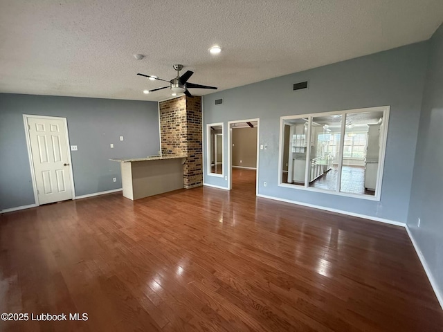 3506 97th St, Lubbock, TX 79423 - unfurnished living room with a textured ceiling, wood finished floors, ceiling fan, and baseboards
