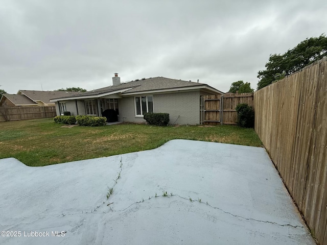 3506 97th St, Lubbock, TX 79423 - rear view of property with a patio area, brick siding, and a chimney