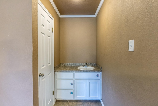 bathroom featuring vanity, crown molding, and a textured ceiling