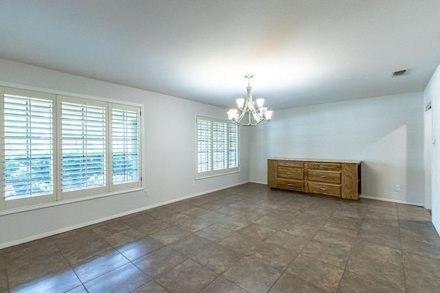 empty room with a notable chandelier