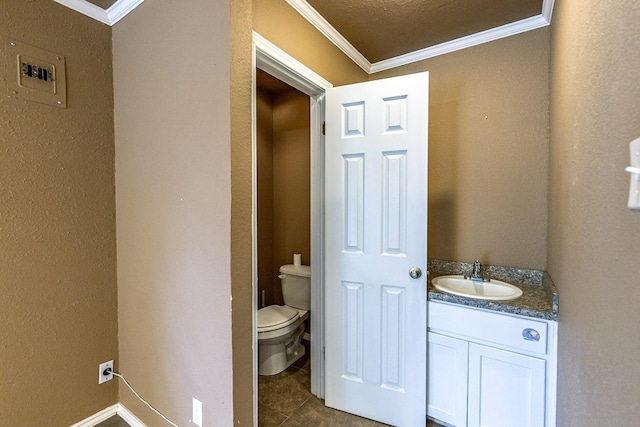 bathroom with vanity, tile patterned floors, crown molding, and toilet