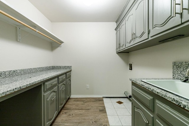 washroom with washer hookup, sink, dark hardwood / wood-style floors, and cabinets