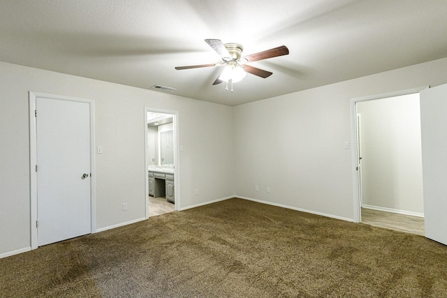 empty room with ceiling fan and light carpet