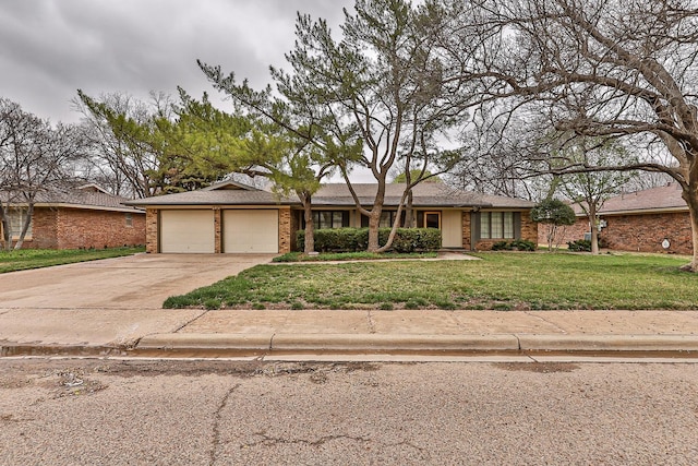 view of front of property with a garage and a front lawn