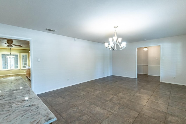 empty room with ceiling fan with notable chandelier