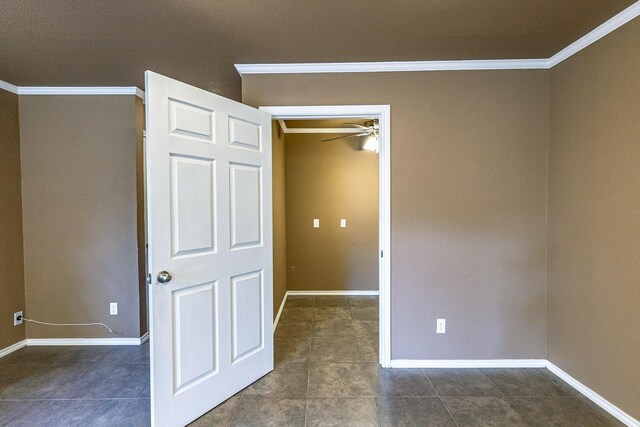 unfurnished bedroom with ornamental molding and dark tile patterned floors