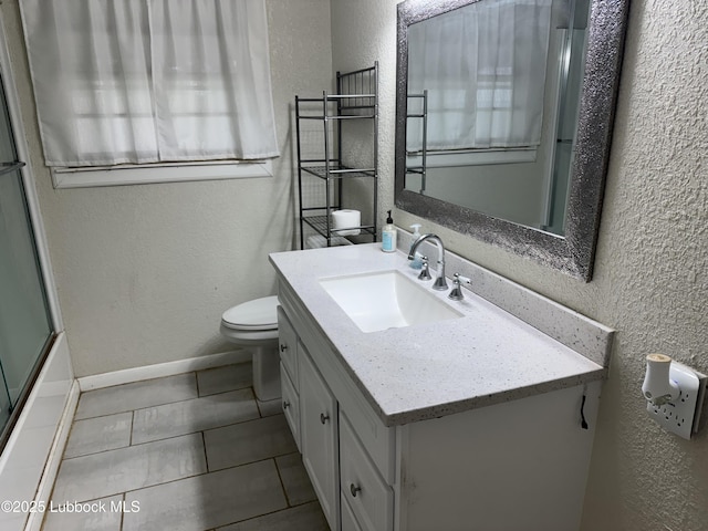 2721 52nd St, Lubbock, TX 79413 - bathroom with toilet, bath / shower combo with glass door, tile patterned floors, vanity, and a textured wall
