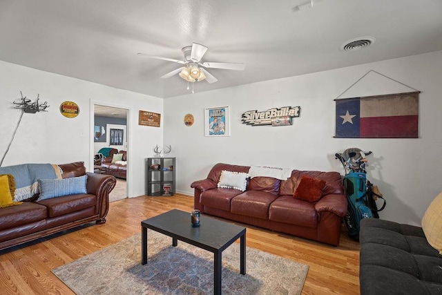 living room with hardwood / wood-style flooring and ceiling fan