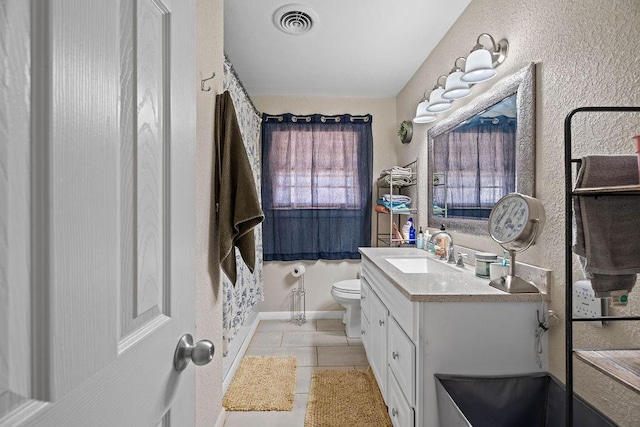 bathroom featuring tile patterned flooring, vanity, curtained shower, and toilet