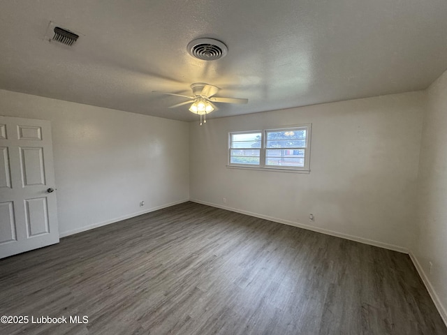 2721 52nd St, Lubbock, TX 79413 - empty room with dark wood-style flooring, baseboards, ceiling fan, and visible vents