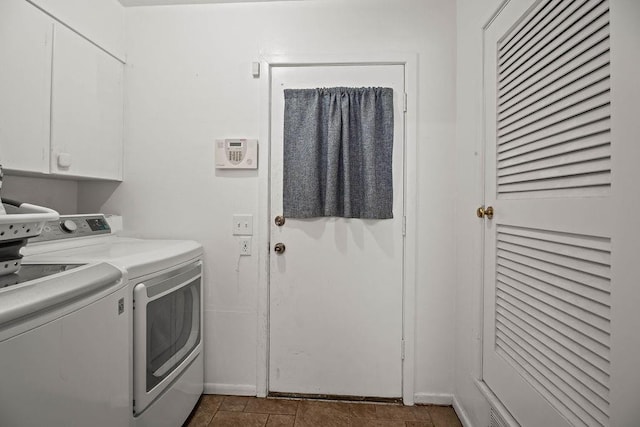 washroom with washer and clothes dryer and cabinets