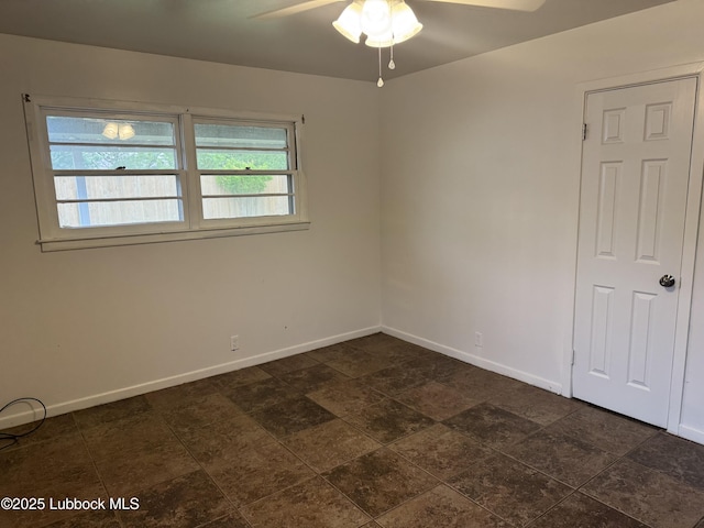 2721 52nd St, Lubbock, TX 79413 - unfurnished room featuring baseboards, a ceiling fan, and stone finish flooring