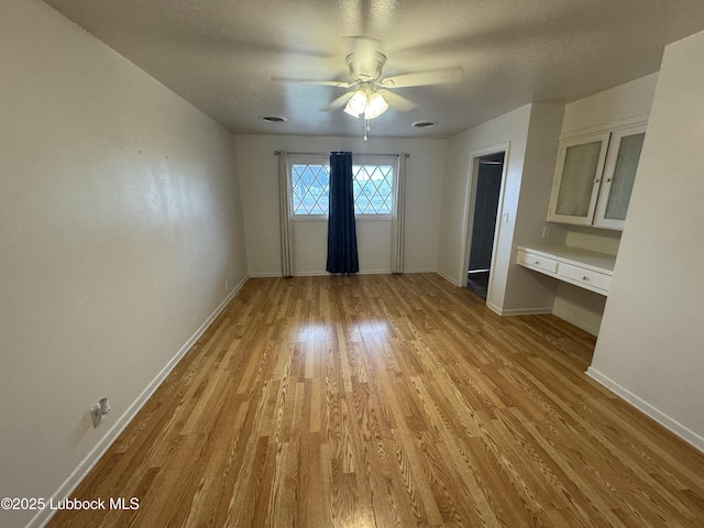 2721 52nd St, Lubbock, TX 79413 - interior space with baseboards, light wood-style flooring, ceiling fan, and built in study area