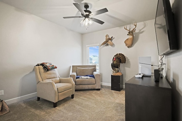 sitting room featuring ceiling fan and light colored carpet