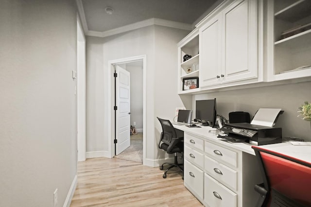 office space with crown molding and light hardwood / wood-style flooring