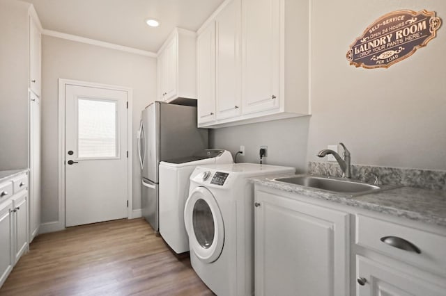 laundry area with washer and dryer, sink, cabinets, ornamental molding, and light wood-type flooring