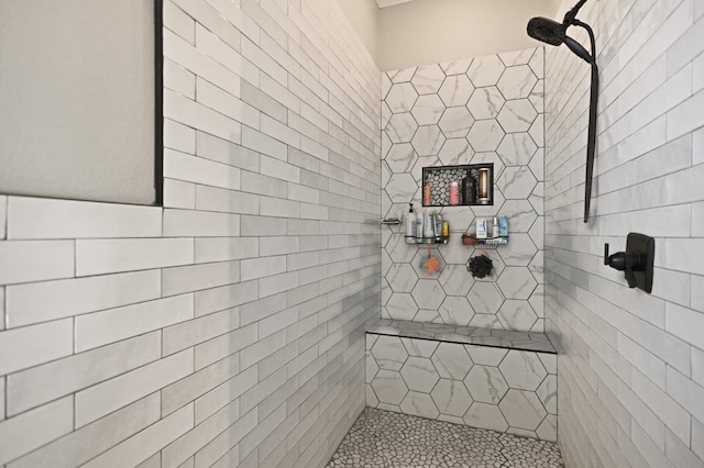 bathroom with a tile shower