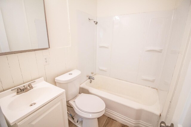 full bathroom featuring vanity, toilet, hardwood / wood-style floors, and shower / bathing tub combination