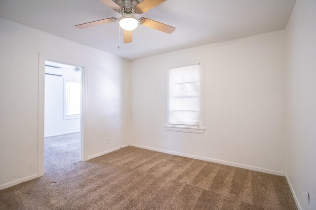 carpeted empty room featuring ceiling fan