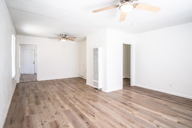 unfurnished room with ceiling fan and light hardwood / wood-style floors