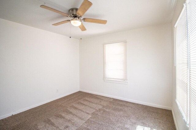 carpeted spare room with ceiling fan