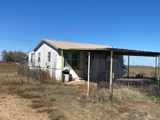 back of property with a carport