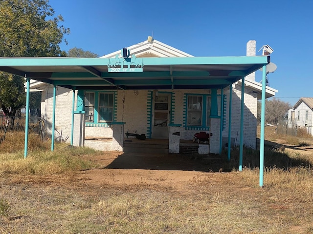 view of front of home featuring a carport and a porch