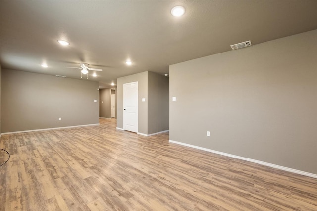 empty room with light hardwood / wood-style flooring and ceiling fan