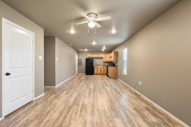 unfurnished living room featuring ceiling fan and light wood-type flooring