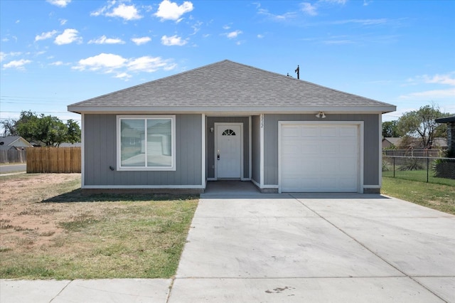 ranch-style house with a garage and a front yard