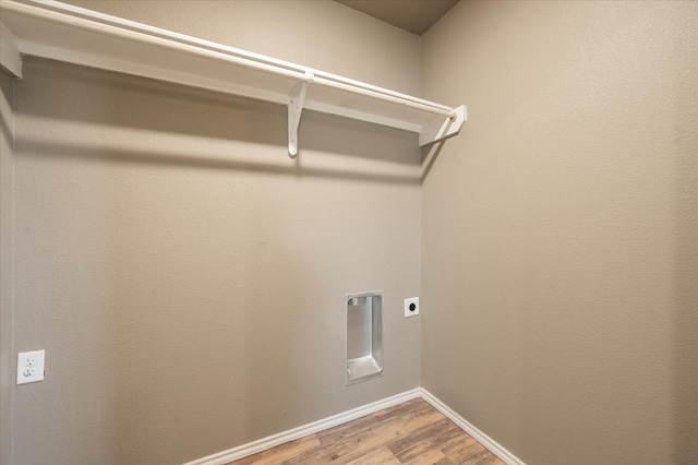 washroom featuring hardwood / wood-style flooring and electric dryer hookup