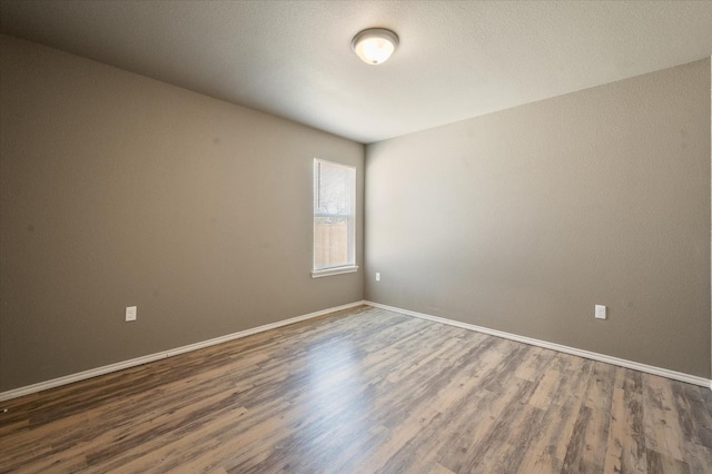 unfurnished room featuring dark hardwood / wood-style flooring