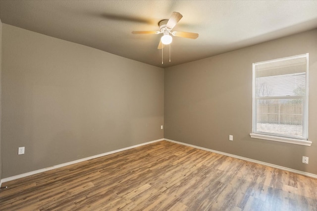 unfurnished room featuring hardwood / wood-style floors and ceiling fan