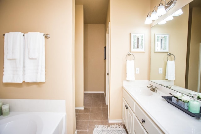 bathroom with vanity, a bath, and tile patterned floors