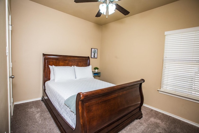 bedroom featuring ceiling fan and dark colored carpet