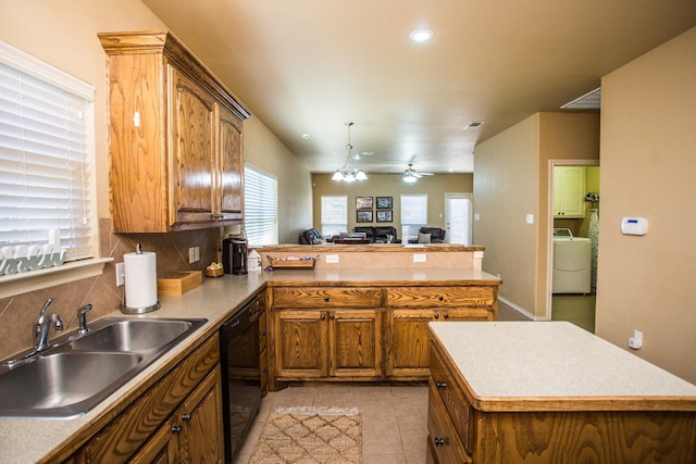 kitchen with washer / dryer, sink, dishwasher, kitchen peninsula, and backsplash