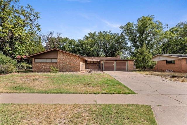 ranch-style home featuring a garage and a front yard