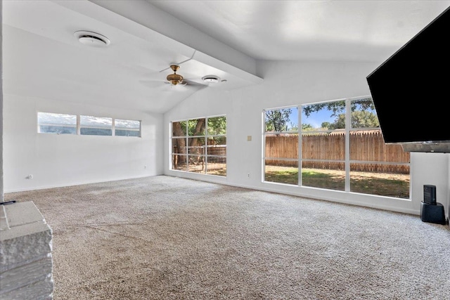 unfurnished living room featuring ceiling fan, lofted ceiling, and carpet flooring