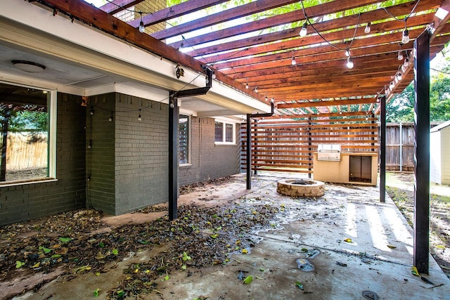 view of patio featuring a pergola and a fire pit