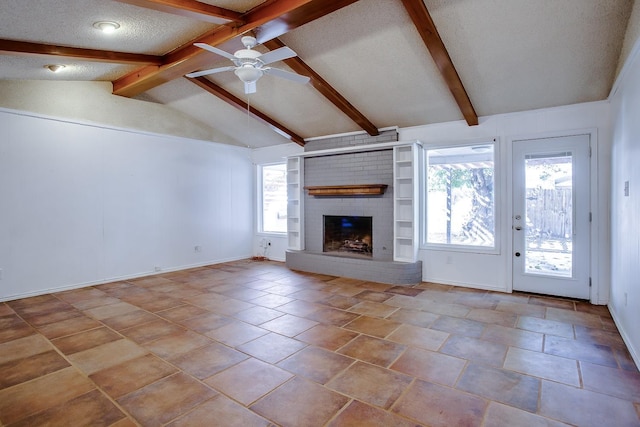 unfurnished living room featuring a brick fireplace, vaulted ceiling with beams, a textured ceiling, and ceiling fan