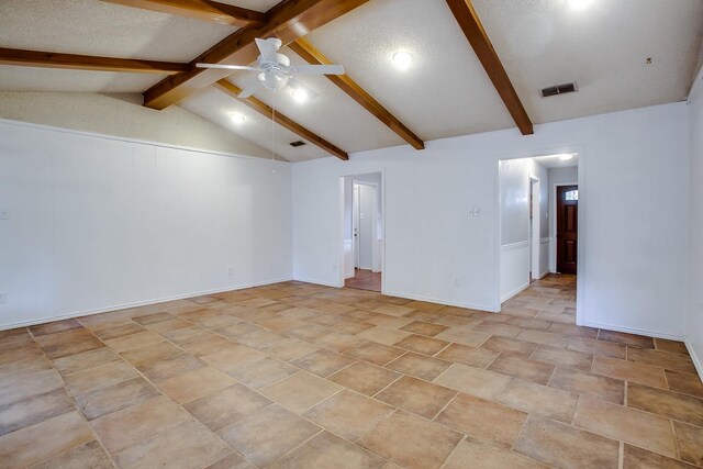 empty room with ceiling fan, a textured ceiling, and vaulted ceiling with beams