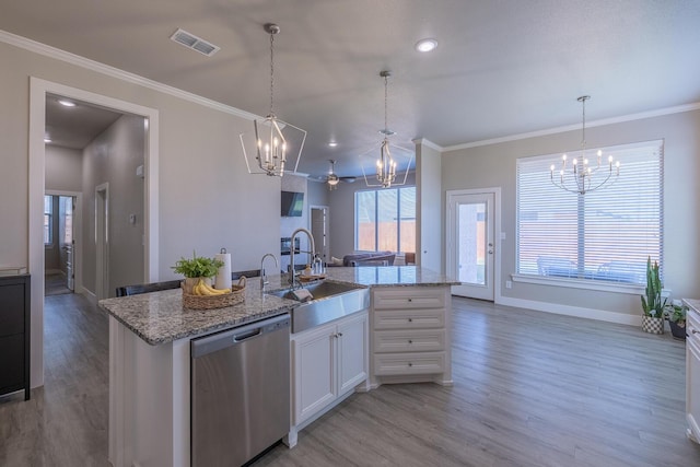 kitchen with stainless steel dishwasher, crown molding, visible vents, and a sink