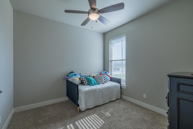 bedroom with light carpet, a ceiling fan, and baseboards