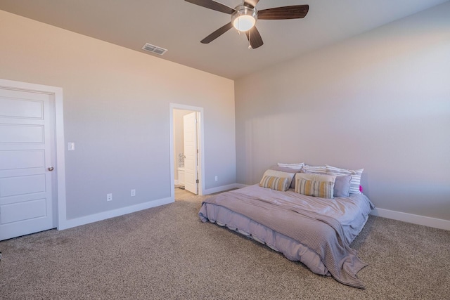 carpeted bedroom with visible vents, connected bathroom, baseboards, and ceiling fan