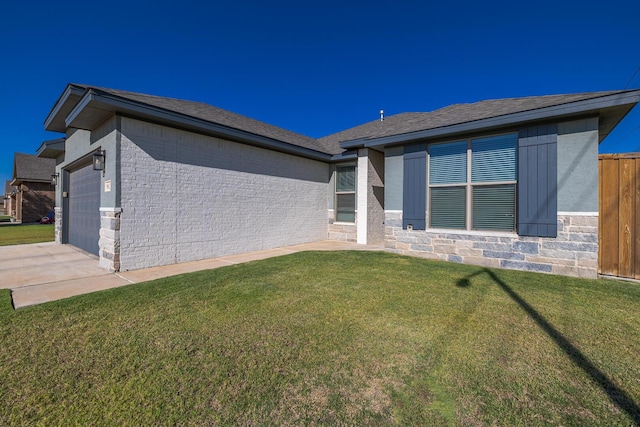 exterior space featuring an attached garage, concrete driveway, stone siding, a lawn, and brick siding