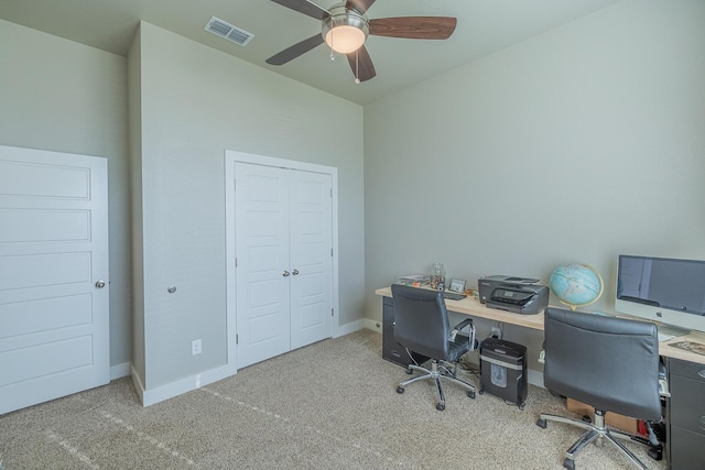 carpeted home office featuring baseboards, visible vents, and ceiling fan