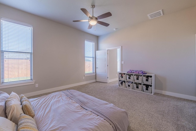 carpeted bedroom with baseboards, visible vents, and ceiling fan