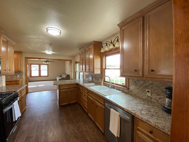 kitchen with sink, stainless steel appliances, tasteful backsplash, dark hardwood / wood-style flooring, and kitchen peninsula