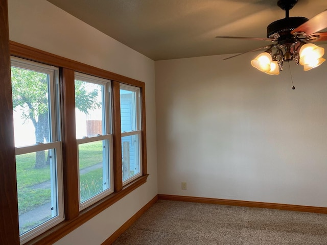 carpeted spare room with ceiling fan