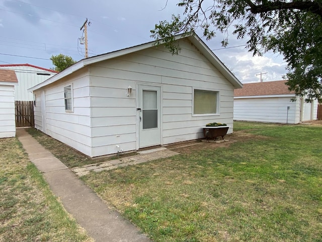 rear view of property with a lawn